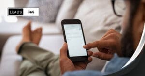 Man checking lead generation email on smartphone.